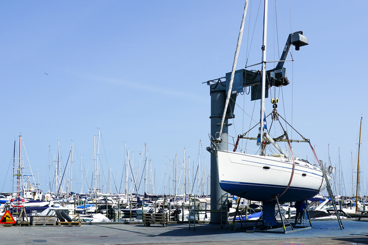 The yacht lifted ashore by a sailboat lift for the repair and maintenance of the underwater part of the hull